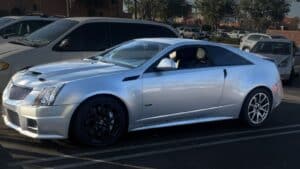 Stolen silver 2011 Cadillac CTS-V Coupe, VIN 1G6DV1EP1B0120393, License 9SAJ983. Features black rims, tinted tail lights, and body-matched spoiler. Stolen in Long Beach, CA.