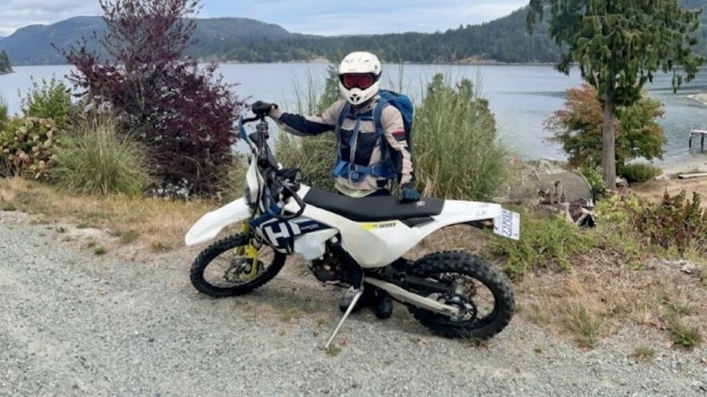 Stolen 2018 Husqvarna FE350S motorcycle (VIN #VBKUAH405JM223943) missing from Vancouver, BC." and "Profile view of the stolen white 2018 Husqvarna FE350S with blue and yellow accents.