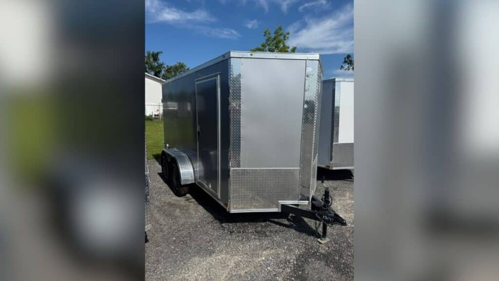 Silver 2025 Xtreme 12-foot dual-axle V-nose utility trailer.