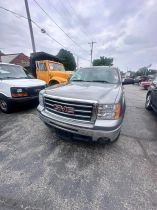 Stolen gray 2013 GMC Sierra 1500 pickup truck (VIN #3GTP2VE7XDG144765) missing from Milwaukee, WI." and "Side view of stolen gray 2013 GMC Sierra 1500.