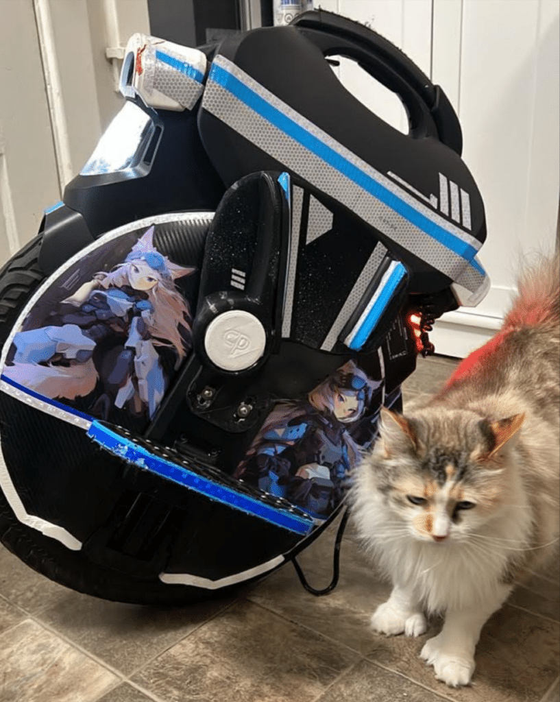 Stolen black InMotion V11 electric unicycle with custom anime cat-girl decals missing from San Francisco." and "Close-up of the stolen InMotion V11 showing the distinctive anime decals and blue/silver striping.