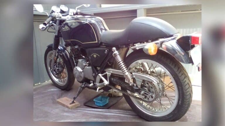 Stolen black 1990 Honda GB500TT vintage motorcycle with VIN JH2PC1612LK100063 parked outdoors.