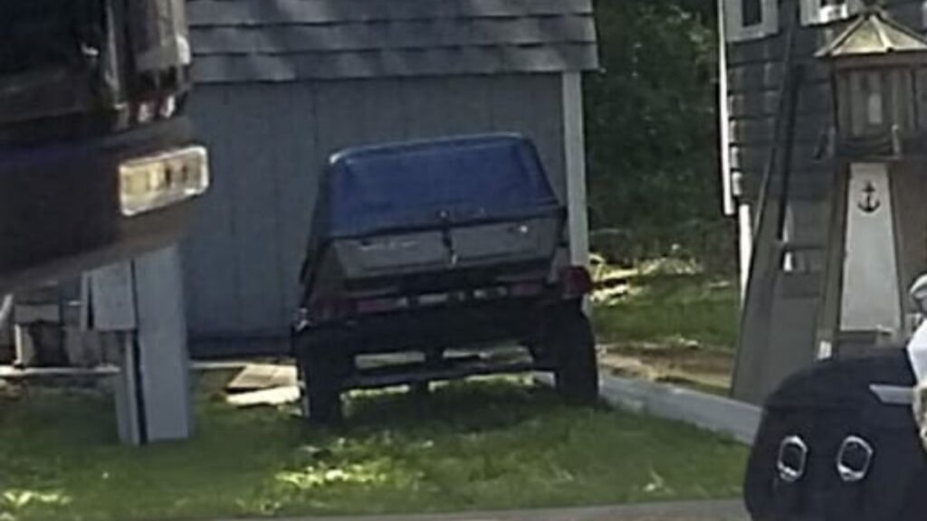Stolen blue and gray custom built motorcycle trailer with a plastic car-top carrier bolted to the frame.