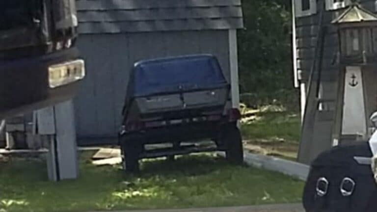 Stolen blue and gray custom built motorcycle trailer with a plastic car-top carrier bolted to the frame.